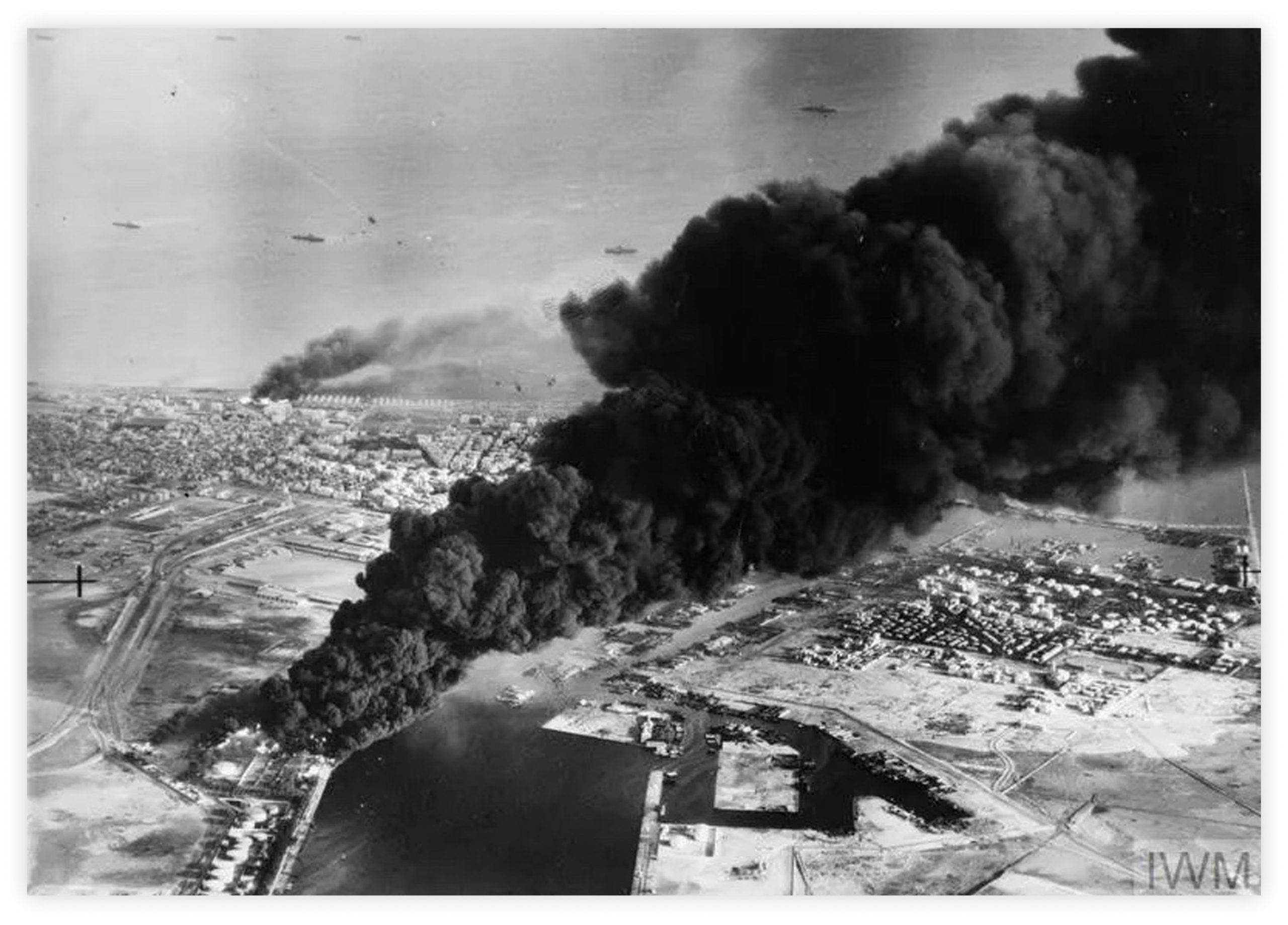 Smoke rises from oil tanks beside the Suez Canal hit during the initial Anglo-French assault on Port Said in 1956.