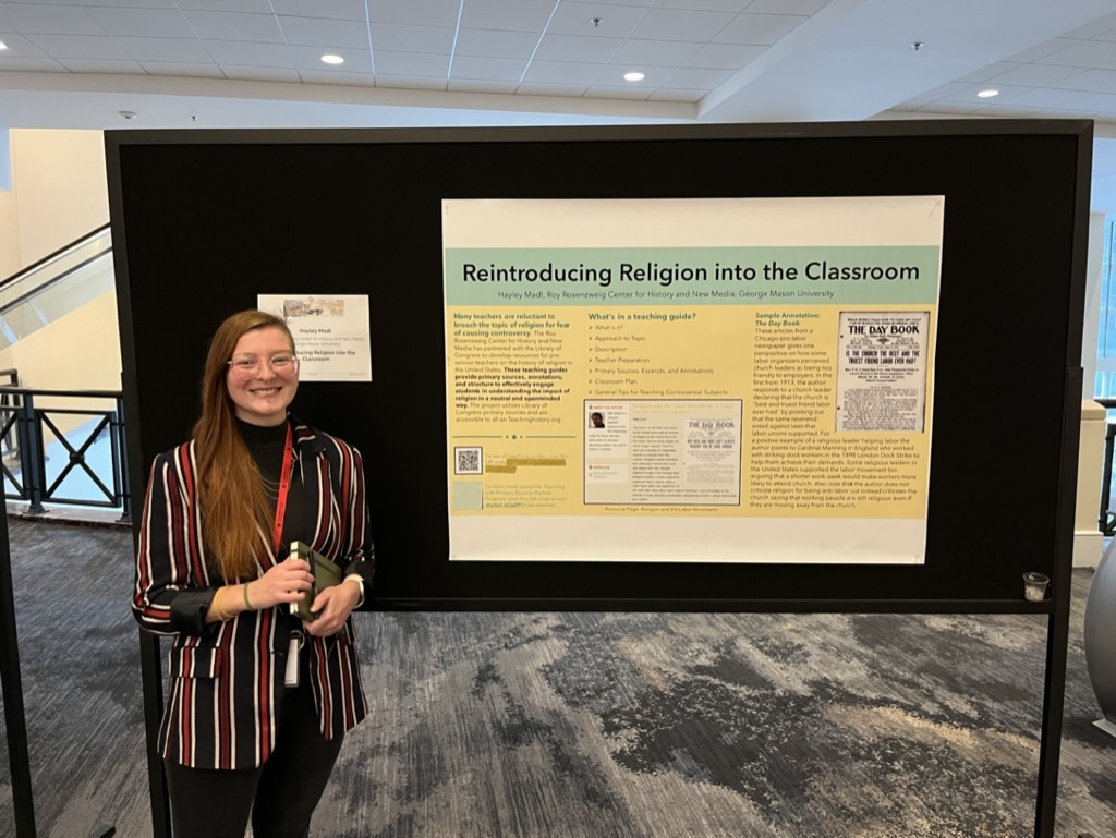 Hayley Madl standing in front of her poster "Reintroducing Religion into the Classroom" at the AHA poster session.