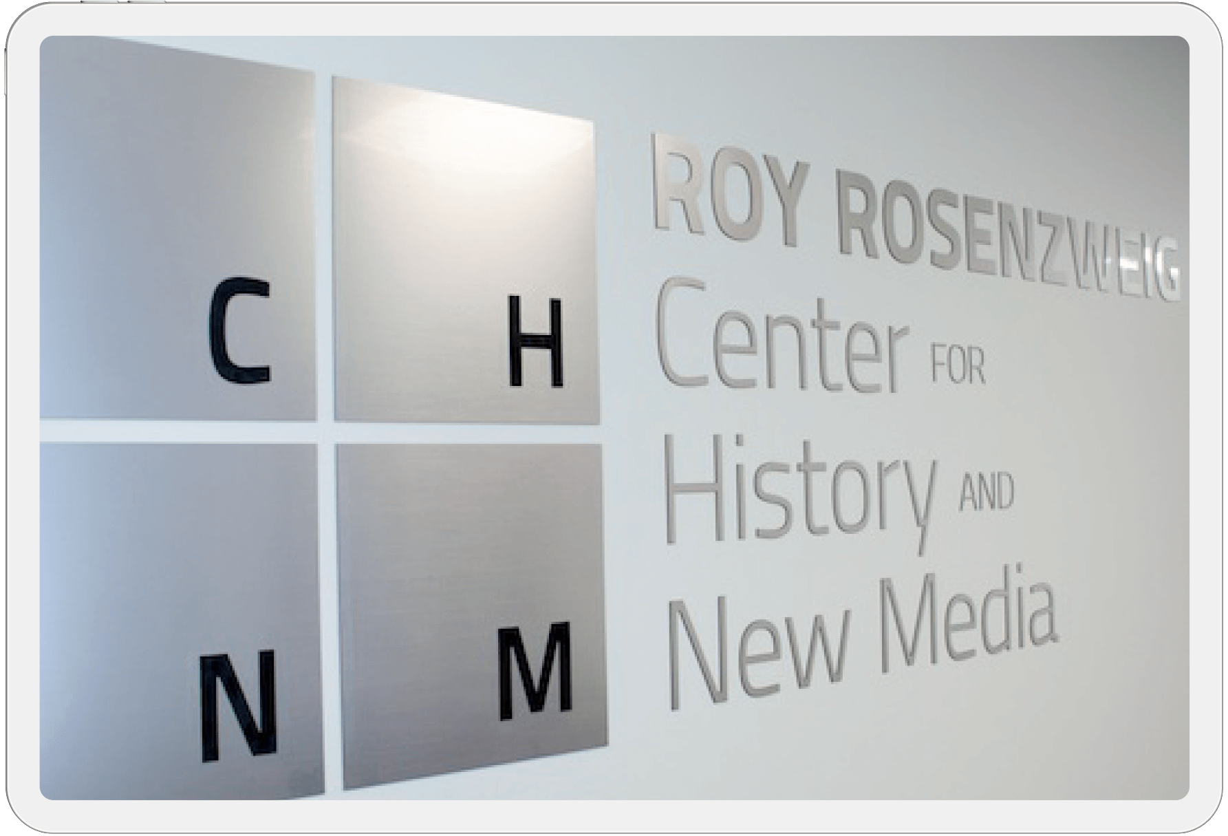 Metal sign version of RRCHNM's logo outside the CHNM office space.